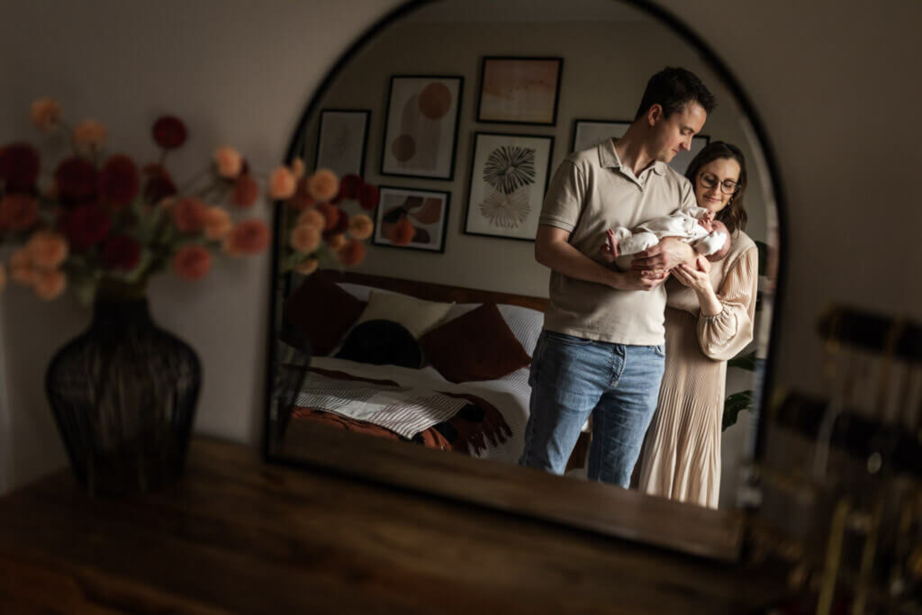 mother holding her newborn baby at home during a natural newborn photography session in Glasgow