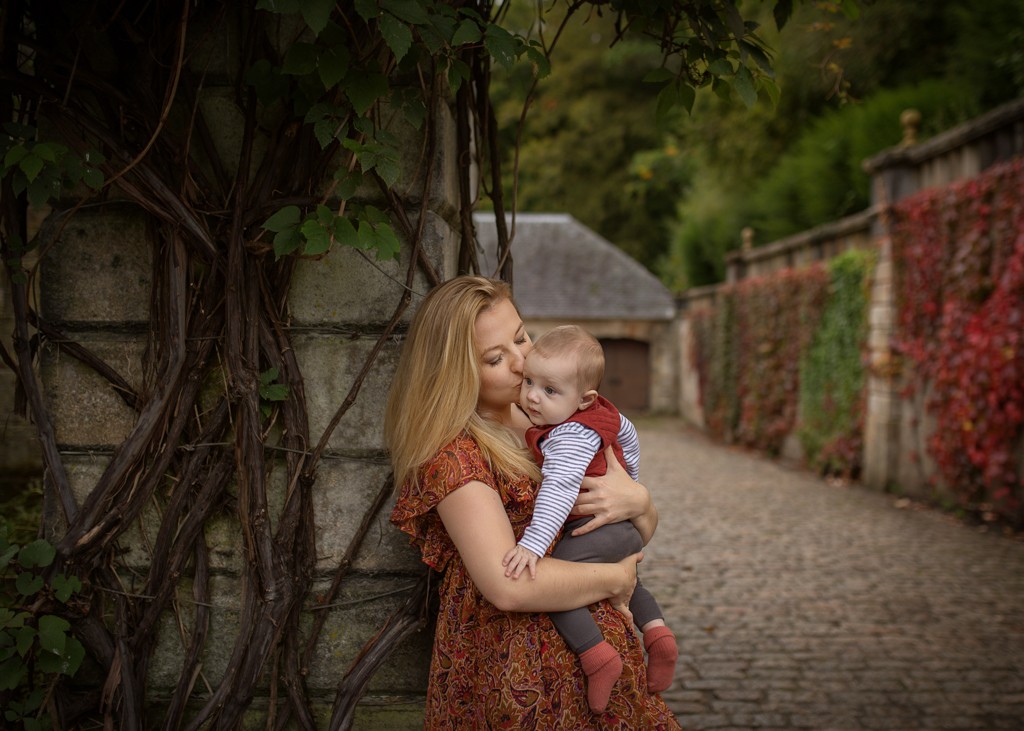 mother in floral maxi dress with toddler baby son at the autumn Pollok Country Park, Family outdoor photoshoot
