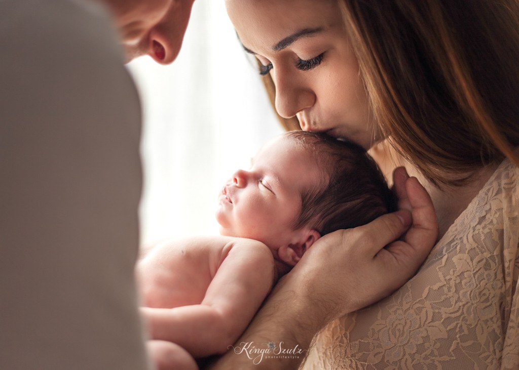 new baby girl with father and mother in boho lace dress, in home newborn photography