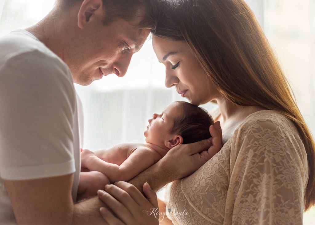 newborn baby girl with father and mother in boho lace dress, in home newborn photography