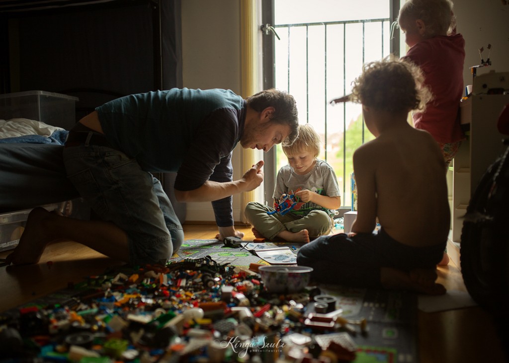 dad and three children playing lego, in home family photoshoot