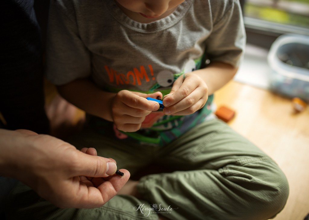 dad and boy playing lego technic, in home family photoshoot