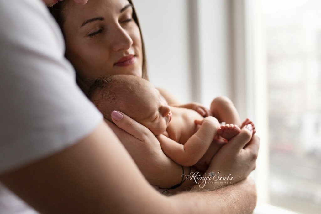 5 days old new baby girl with parents, in home newborn photoshoot