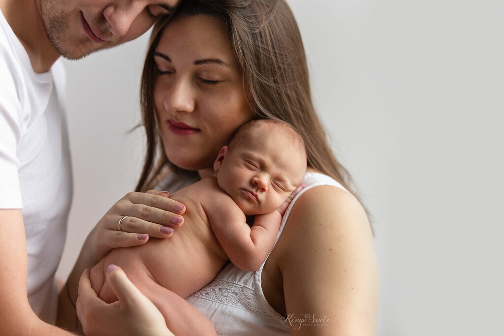 5 days old new baby girl with parents, in home newborn photoshoot