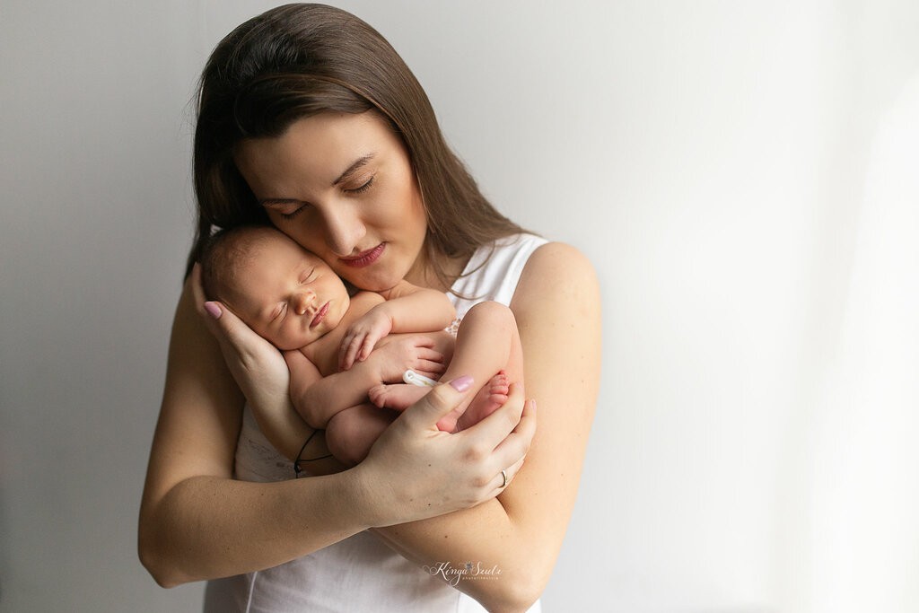 5 days old new baby girl with mother, in home newborn photoshoot