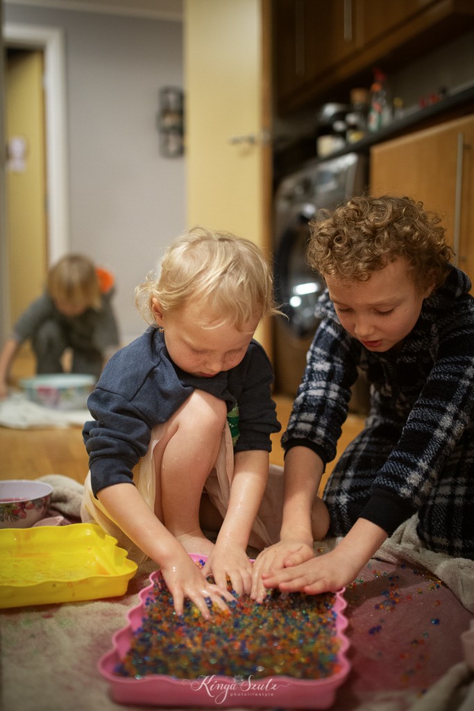 brother and sister playing slime, in home Family photoshoot