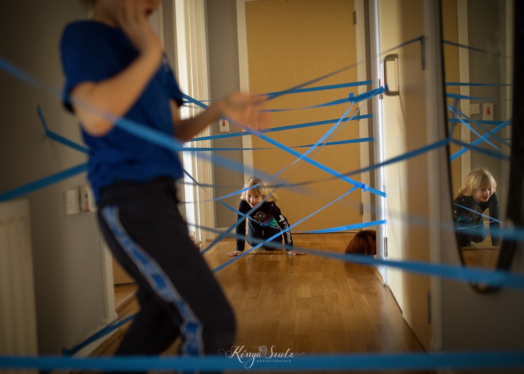 two boys, brothers playing laser maze in the hallway, in home Family photoshoot