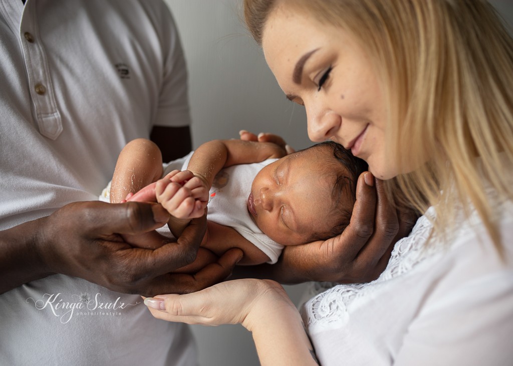 new baby girl, 7 days old, in home newborn photoshoot, mixed family