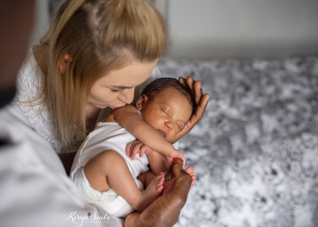 new baby girl, 7 days old, in home newborn photoshoot, mixed family