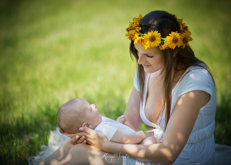 Mother holding her son four-week-old Marcel in the garden during a summer outdoor newborn photoshoot in Glasgow