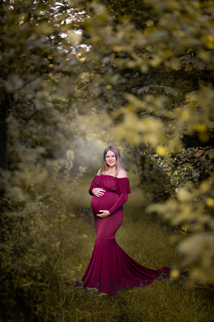 Glasgow Maternity Photography with pregnant women in red long dress at the woodland path