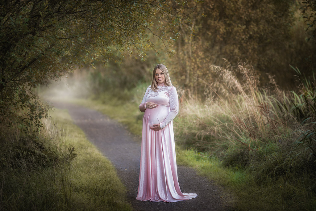 Glasgow Maternity Photography with pregnant women in pink long dress at the woodland paths