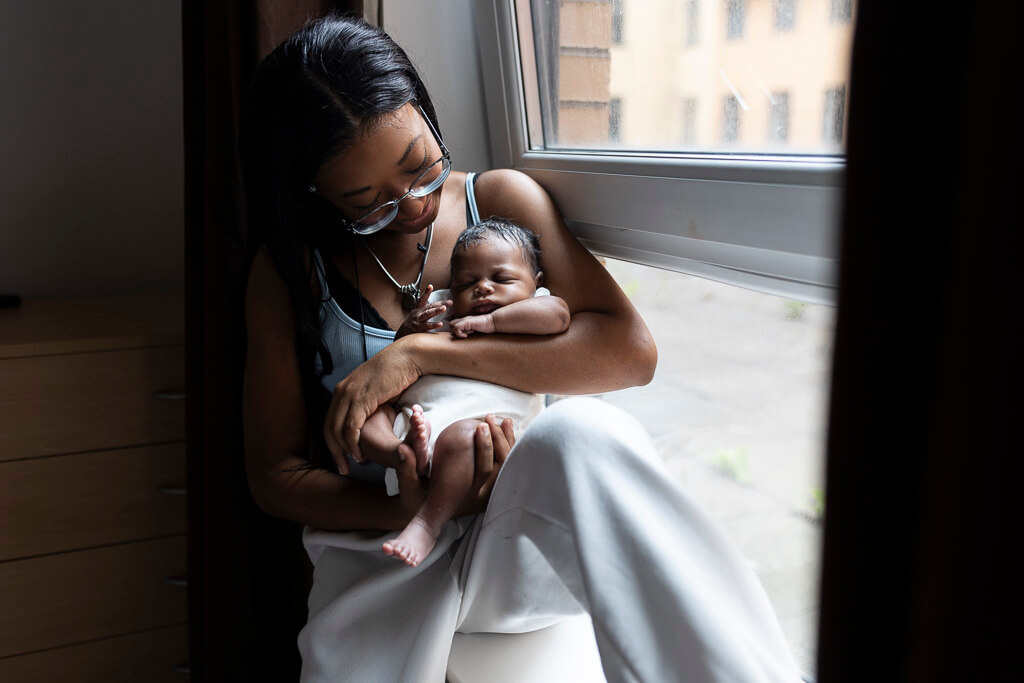 mother holding newborn baby during an in-home newborn session in Glasgow