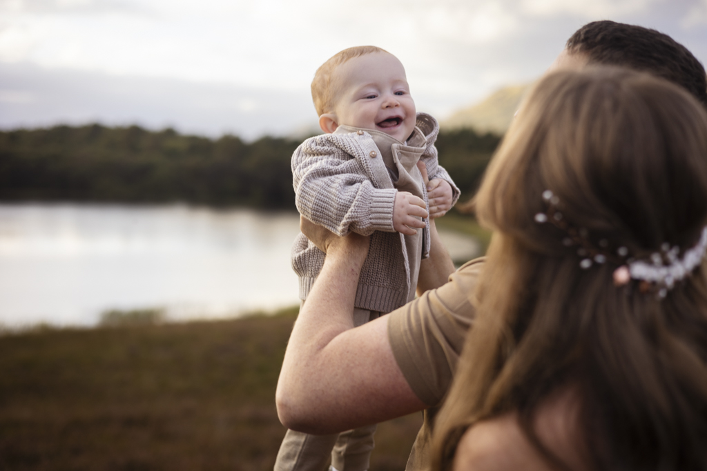 Toddler in comfortable knitted clothing during an outdoor family photoshoot