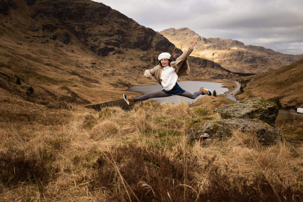 Mother and daughter sharing a laugh during an outdoor family photo session in Scotland. Family photographer capturing authentic family memories and real connection.