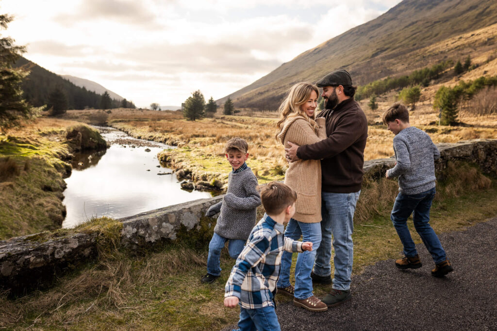 Family enjoying an outdoor photoshoot in Scotland, wearing warm jumpers and comfortable clothes and footwear for easy movement