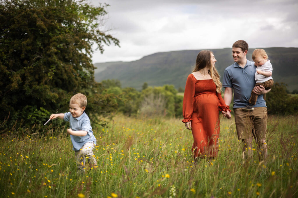 Parents and children enjoying time together outdoors while preparing to welcome a new baby into the family.