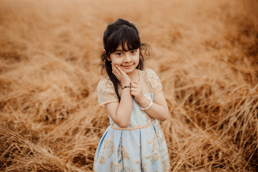 Mother and daughter photoshoot Glasgow featuring natural outdoor family photography in a meadow. Relaxed family photo session in Scotland captured by Family Photography Glasgow, specialising in authentic family portraits and lifestyle photography.