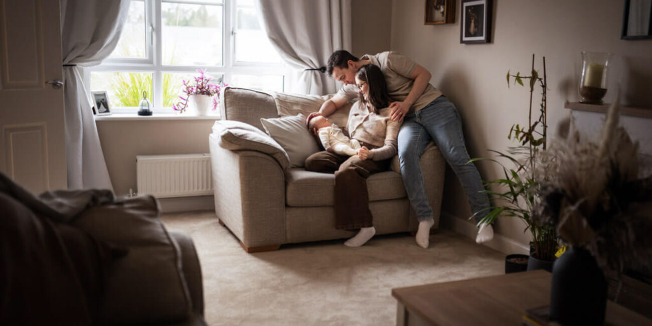family with newborn baby and older sibling during an at-home newborn session in Glasgow