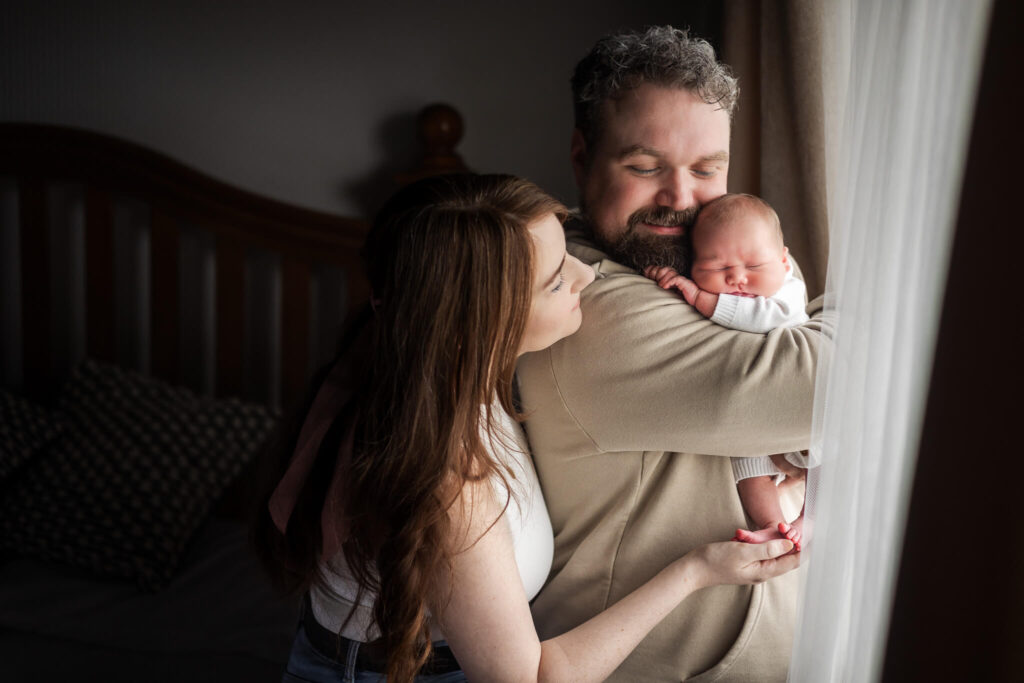 Parents looking at their newborn baby during a relaxed lifestyle photoshoot